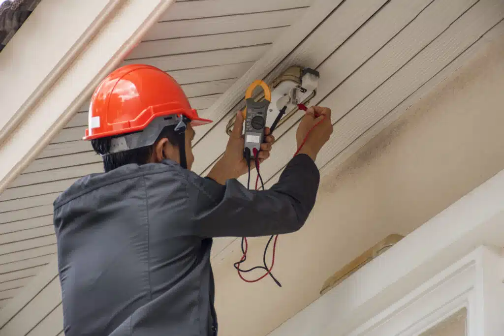 Electrician performing outdoor wiring.