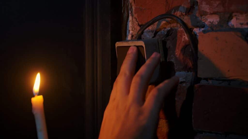 Electric Mysteries, Hand Touching Light Switch Next to Candle Flame.