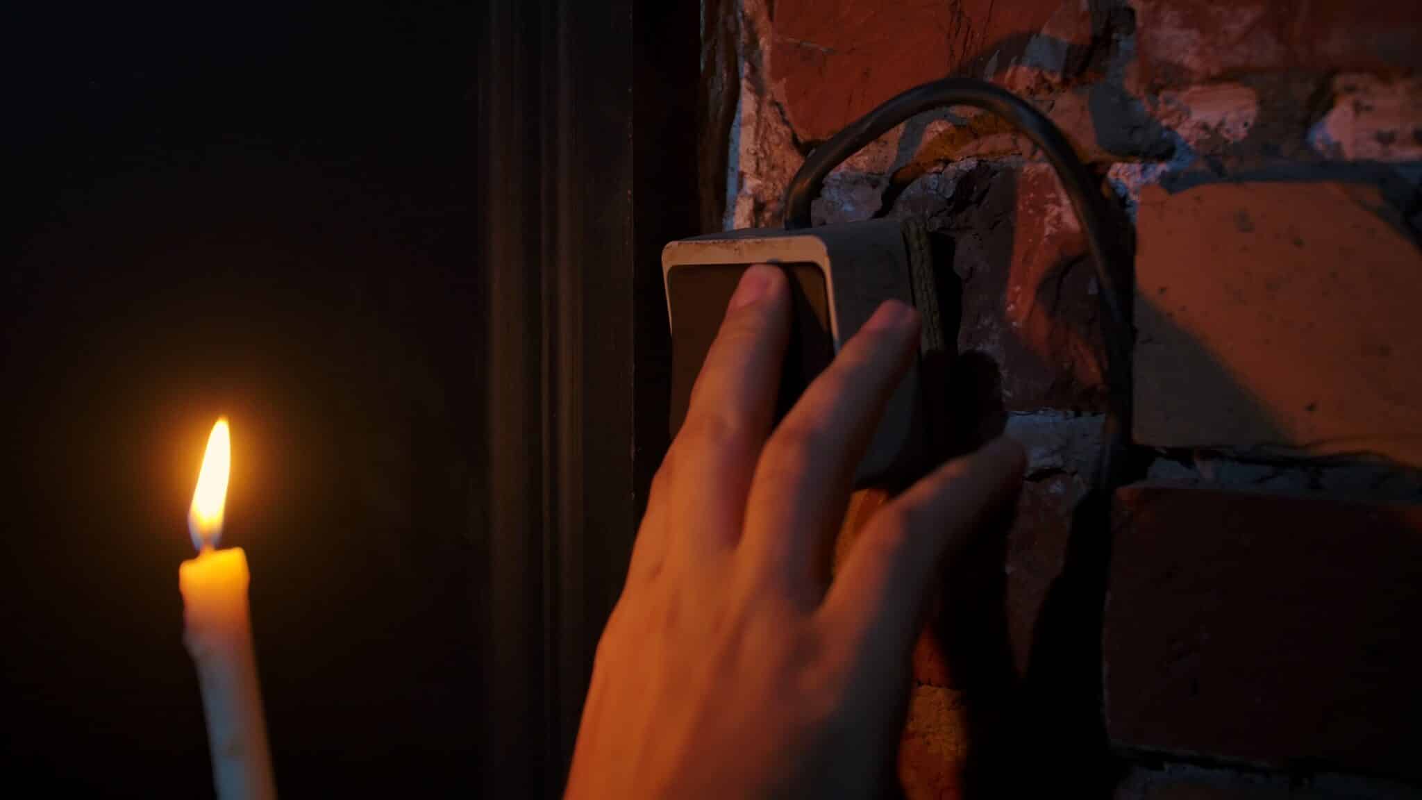 Electric Mysteries, Hand Touching Light Switch Next to Candle Flame.